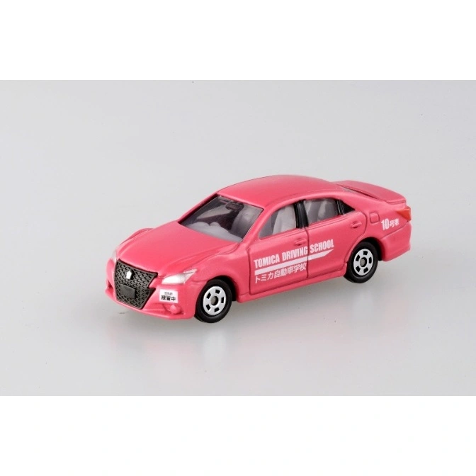  Pink Tomica driving school car toy with Japanese text and white wheels.