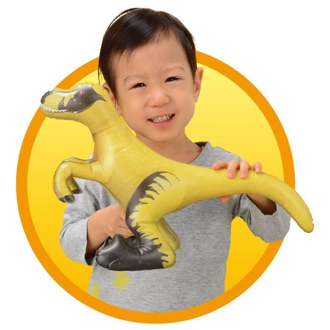  Child holding a yellow inflatable dinosaur toy with black accents, smiling.