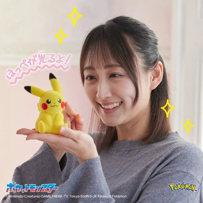  Woman holds a plush Pikachu toy with glowing cheeks. Pokémon merchandise.