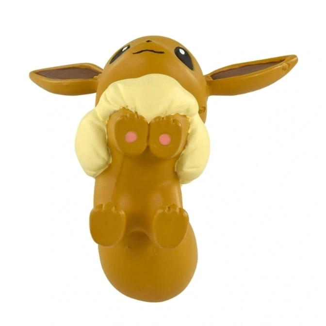  Eevee toy figure lying on its back with paws up.