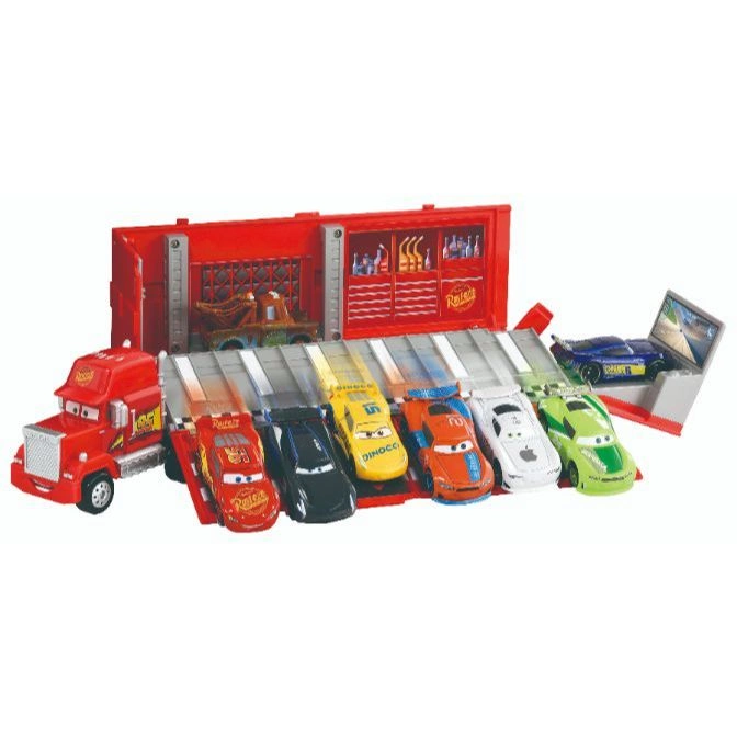  Disney Cars playset with Mack truck, race cars, and garage backdrop.