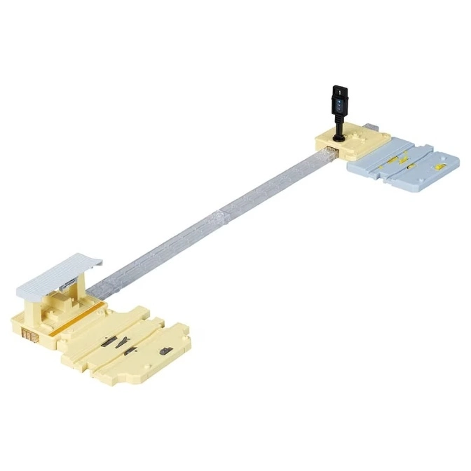 Toy train set with station, track, and signal light.