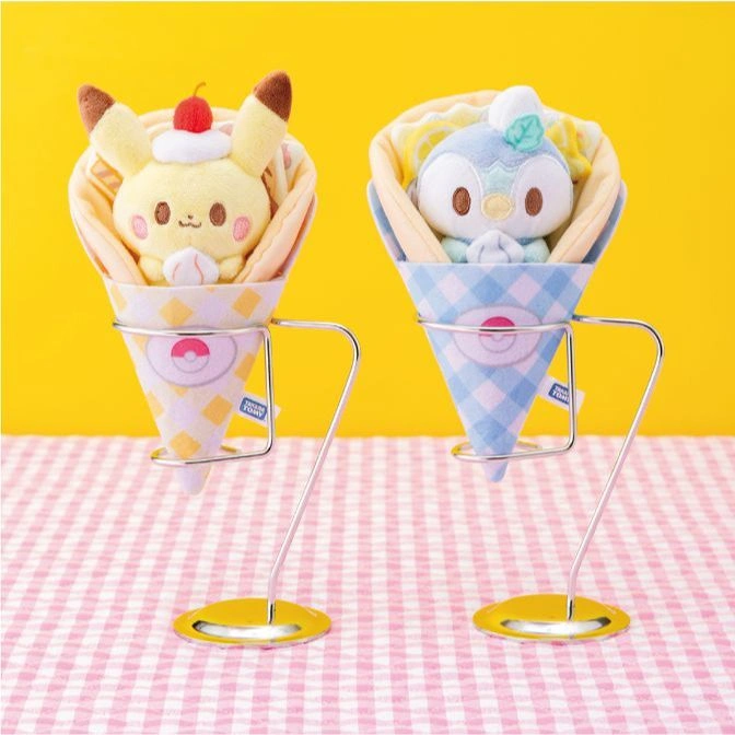  Two Pokémon plush toys in crepe cones on stands: Pikachu with cherry, Piplup with mint leaf.