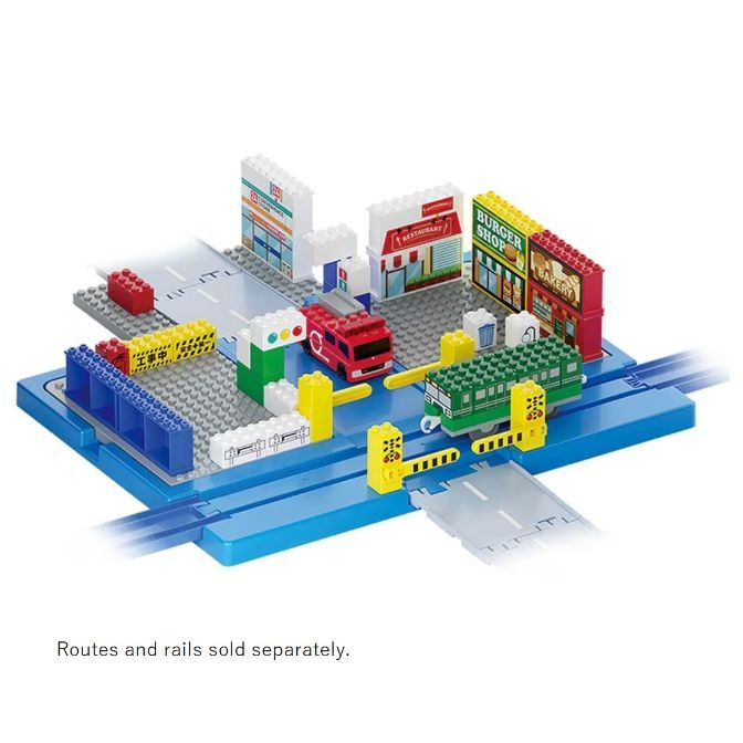  Toy train set with buildings, a train, a car, and a road crossing on a blue base.