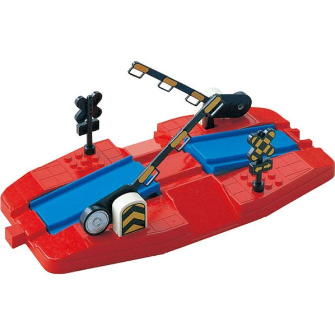 A toy train crossing gate on a red base with blue tracks.