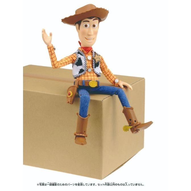  Woody doll sitting on a box, wearing a cowboy hat, vest, and boots.