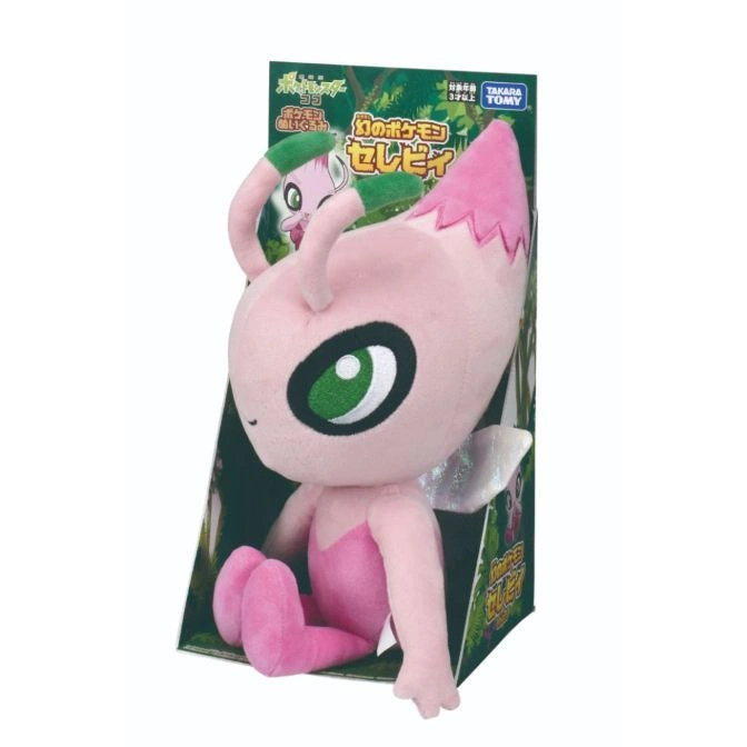  Celebi plush toy in box, pink body, green eye, pink tail, and green antenna.