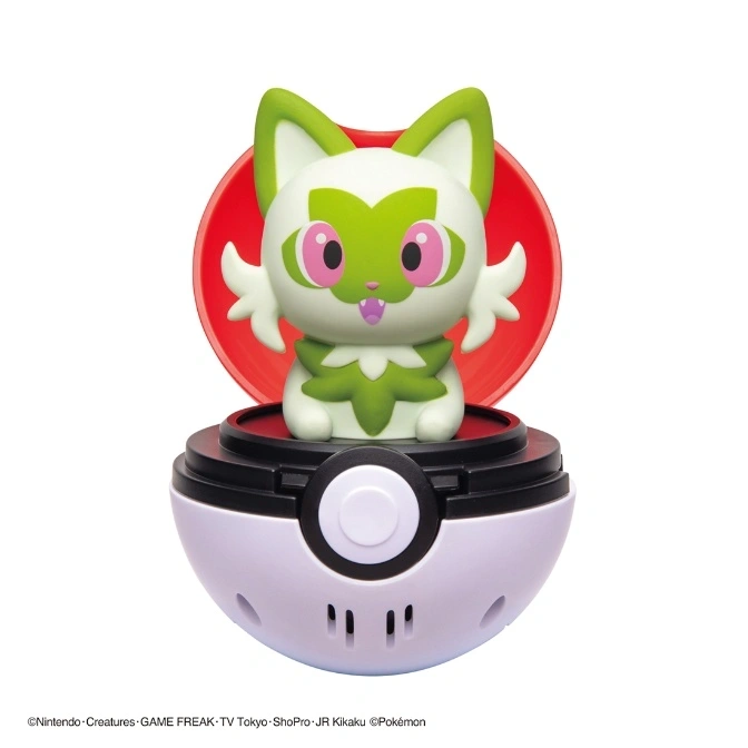 Sprigatito toy in a Poké Ball. The ball is open, revealing the Pokémon inside.