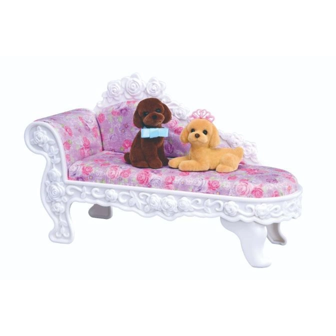 Toy poodle figures on a floral chaise lounge. One is brown with a bow tie, the other is tan.