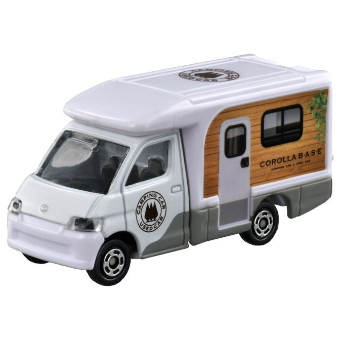 White toy camper van with wood-grain paneling and "Corolla Base" logo.