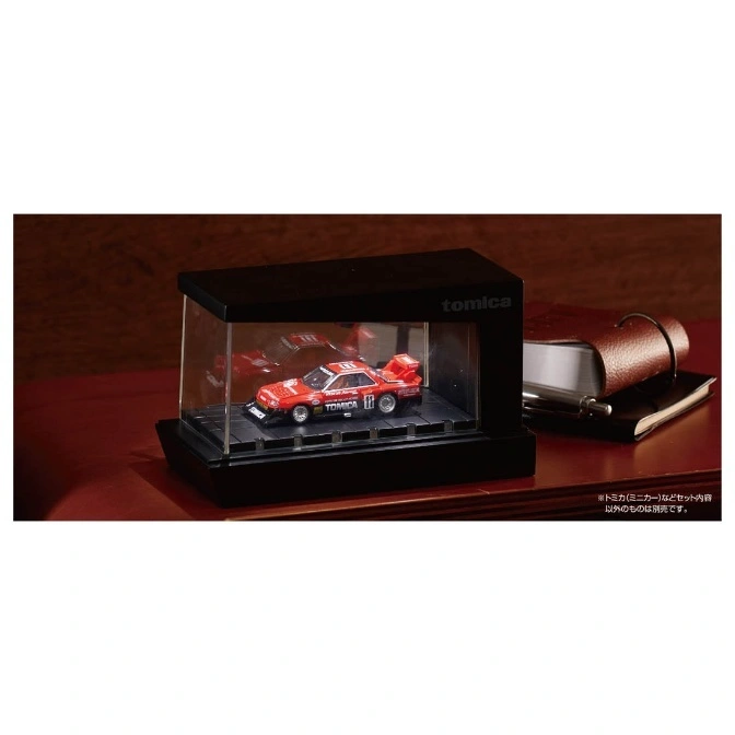  Red Tomica toy car in display case, featuring racing decals and number 11.