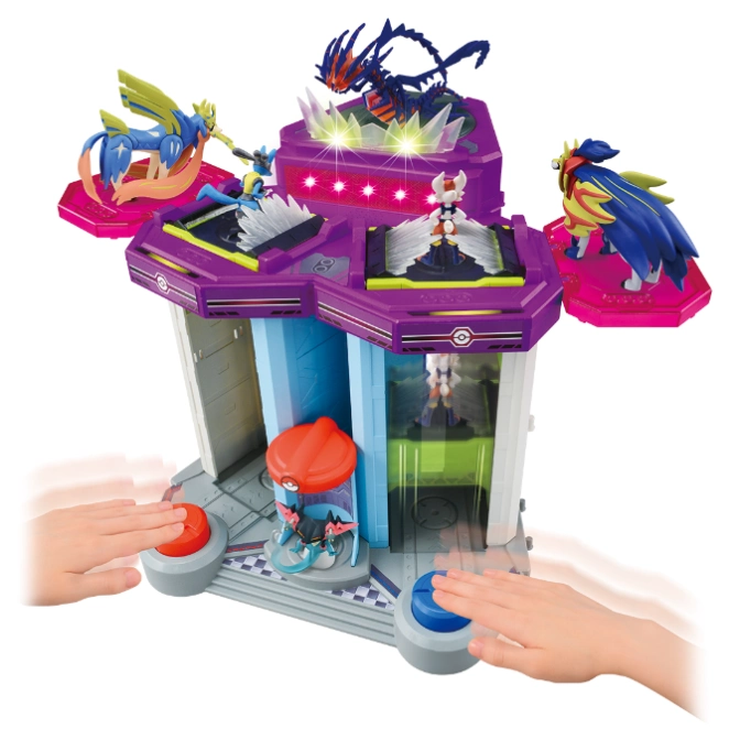 Pokémon playset with figures, buttons, and lights. Hands press buttons to activate features.
