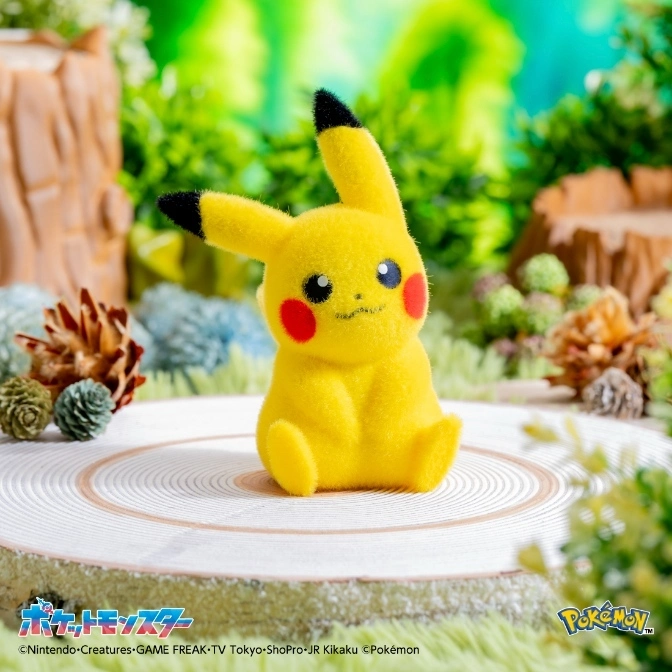  Fluffy Pikachu plush toy sitting on a wood slice, with red cheeks and black-tipped ears.
