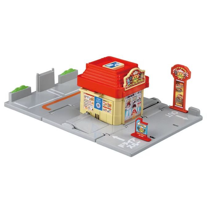 Toy burger shop playset with drive-thru, sign, and road sections.