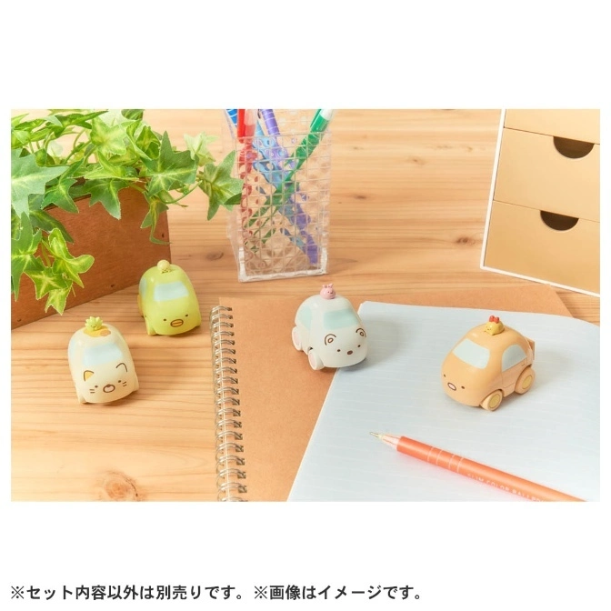  Sumikko Gurashi character cars on a desk with stationery and a plant.