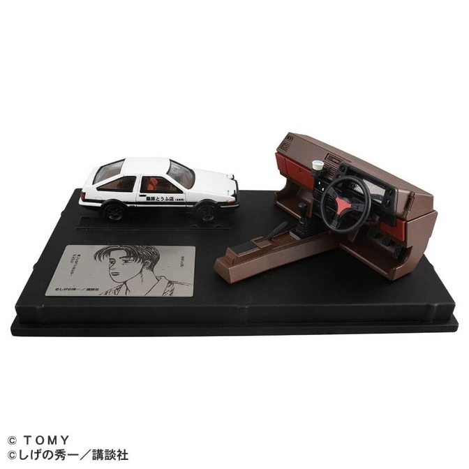  Initial D AE86 model car with interior display on a black base with manga art.
