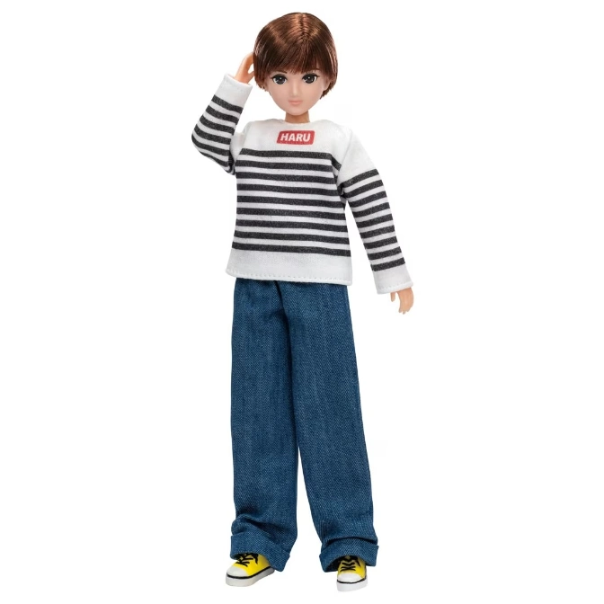  Doll wearing a striped shirt, jeans, and yellow sneakers, with hand near head.