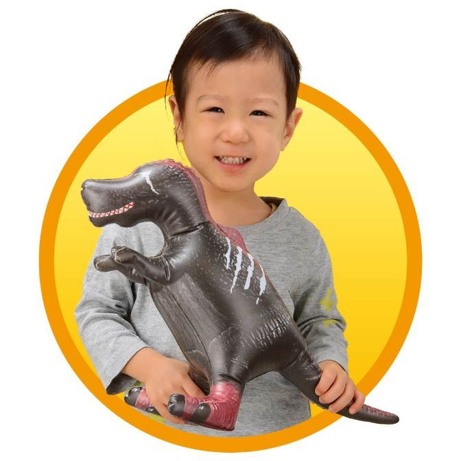  Child holding inflatable dinosaur toy with red accents and white stripes.
