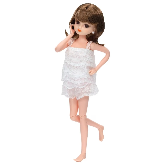  Doll with brown hair in a white lace dress, posing with one leg bent.