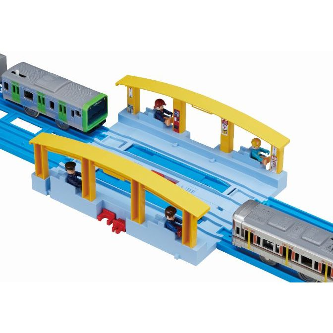  A toy train set with two trains and a station.