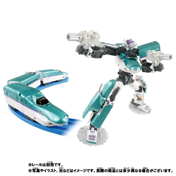  Green transforming toy train robot with guns, next to a toy bullet train on a blue track.