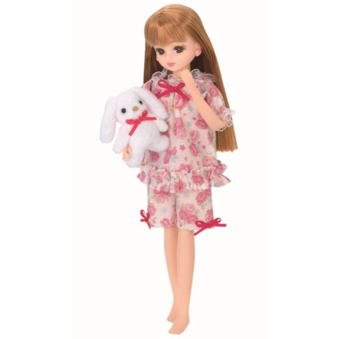 Licca doll in floral pajamas holding a plush bunny toy.