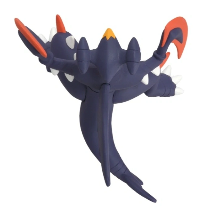  Dark blue toy monster with orange and white accents, spiky features, and a long tail.