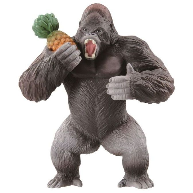  Gorilla toy figure holding a pineapple, mouth open.