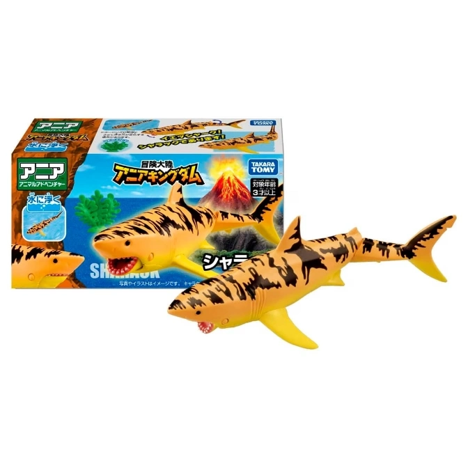  Toy shark with tiger stripes next to its packaging featuring a volcano and the words "Ania Kingdom".