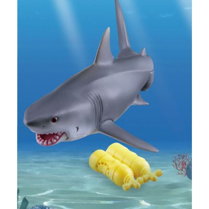  Toy shark with scuba gear. Grey shark with visible teeth and yellow scuba tanks on the ocean floor.