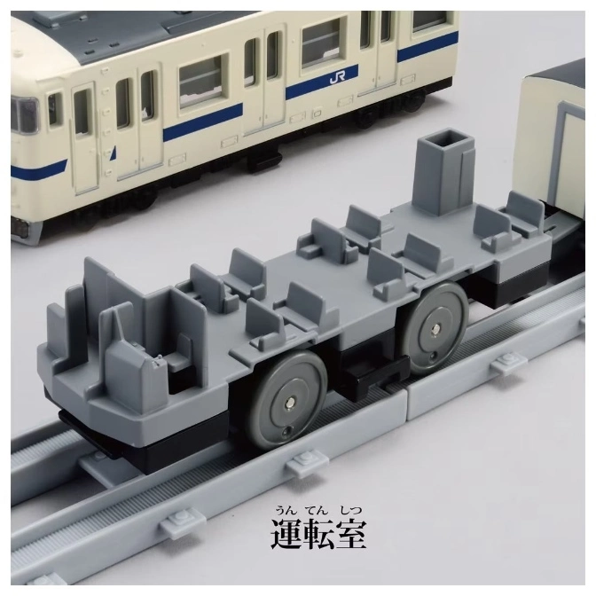  Toy train car with seats on a track, part of a larger train set.