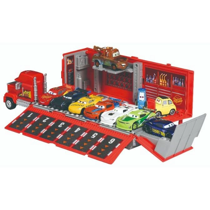 Cars Mack truck playset with Lightning McQueen and friends lined up for a race.