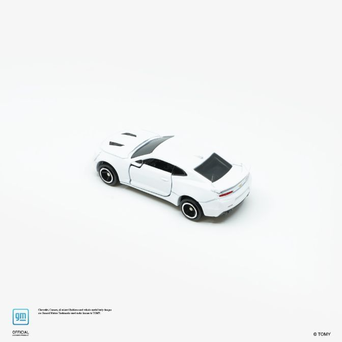  White toy Camaro with black accents, showcasing its sleek design and collectible appeal.