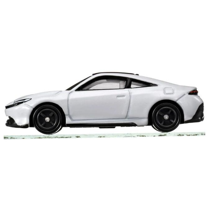  White toy sports car with black wheels and accents, side view.