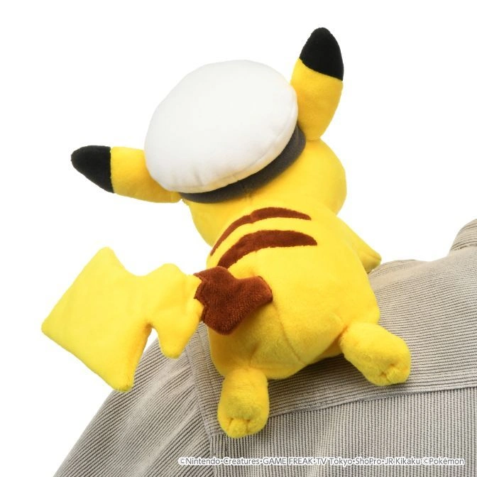  Pikachu plush with a white hat perched on a person's shoulder.