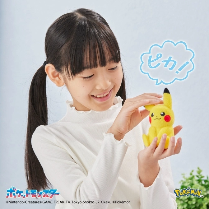  Girl petting a Pikachu plush toy that says "Pika!"