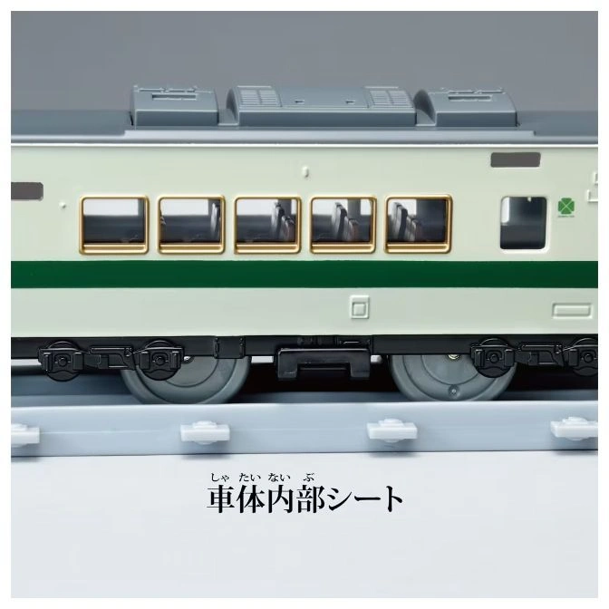  Toy train car with green stripe and detailed interior visible through windows.