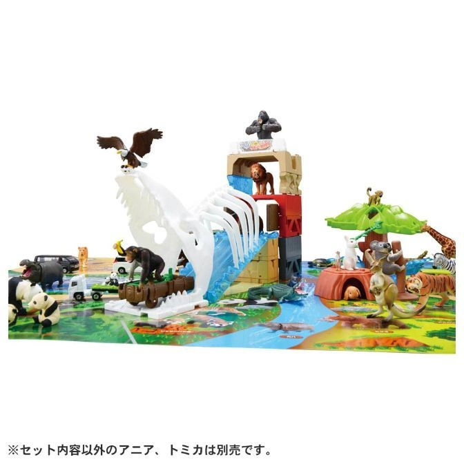  Toy animal playset with skull bridge, tower, tree, and various animal figures.