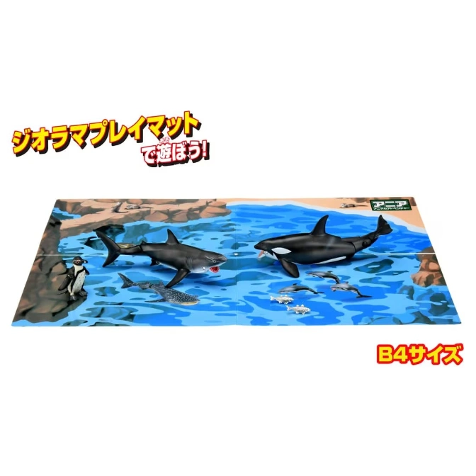  Toy diorama playmat with shark, orca, whale shark, penguin, and small fish figures on a water-themed background.
