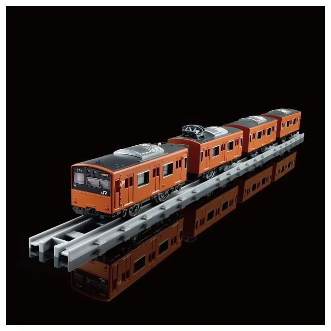  Orange toy train on gray tracks, reflected on a black surface.
