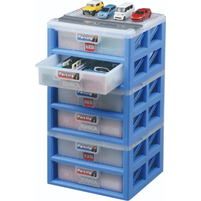  Blue Tomica parking garage toy with cars on top and drawers filled with toy vehicles.