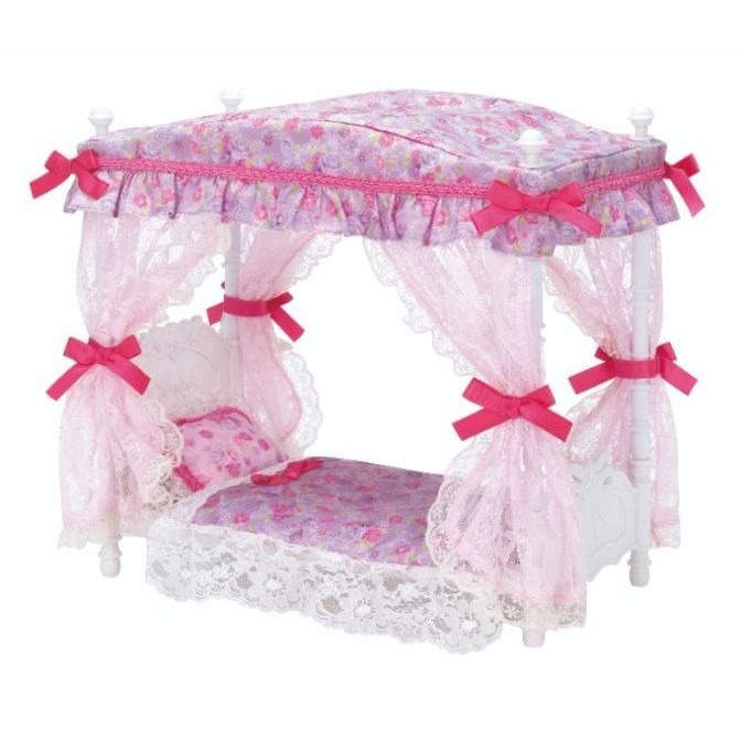  Doll-sized canopy bed with pink floral fabric, lace trim, and pink ribbon accents.