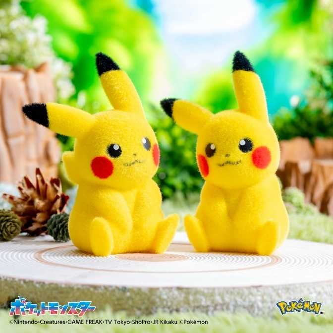  Two fuzzy Pikachu plush toys with red cheeks and black-tipped ears sit on a wood slice.