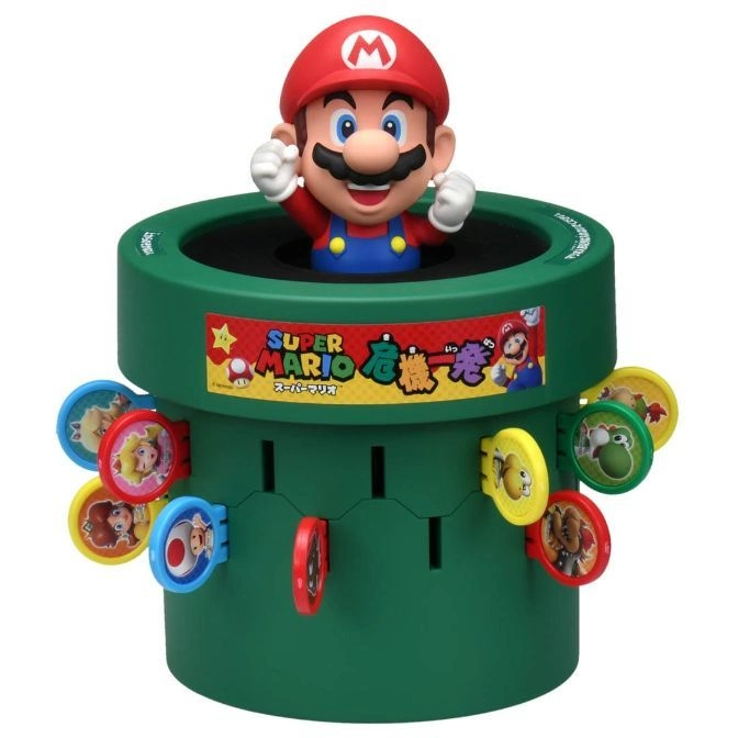 Mario popping out of a green pipe toy with character tokens inserted around the sides.
