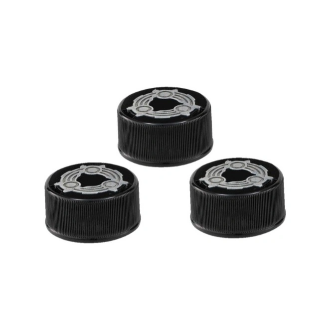 Three black bottle caps with silver gear design on top, arranged on a white background.