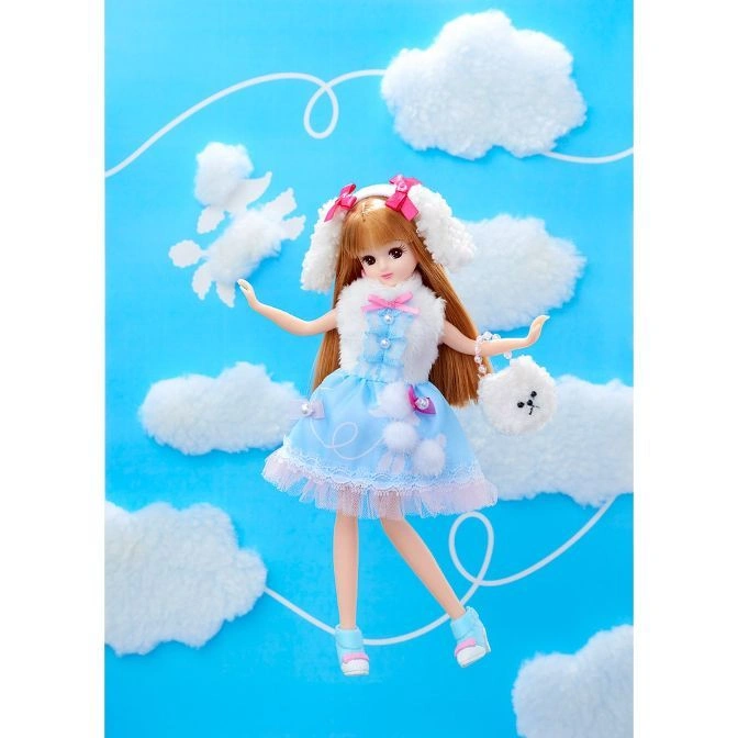  Licca-chan doll in a blue dress with a dog-shaped purse against a sky background with cloud decorations.