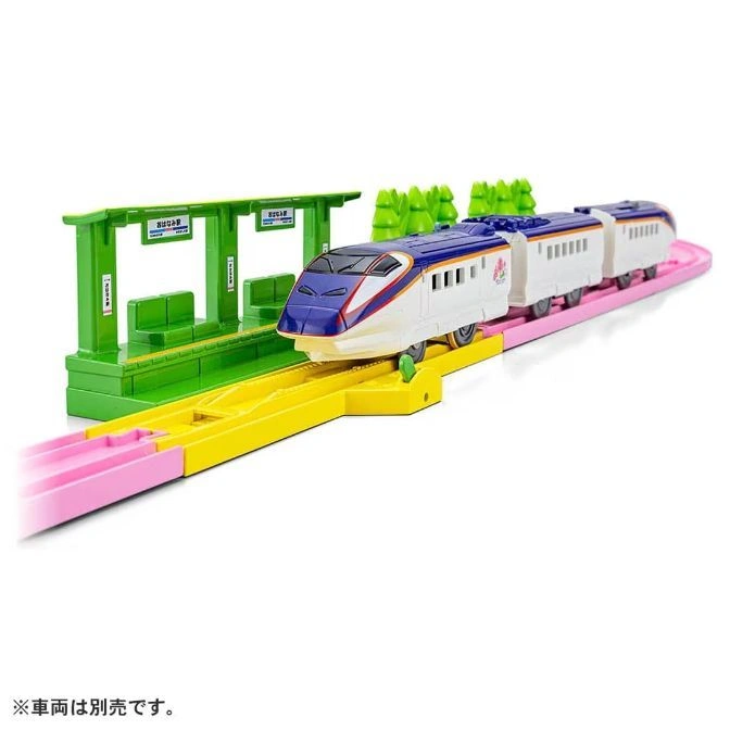  Toy train set with a blue and white bullet train, green station, and pink tracks.