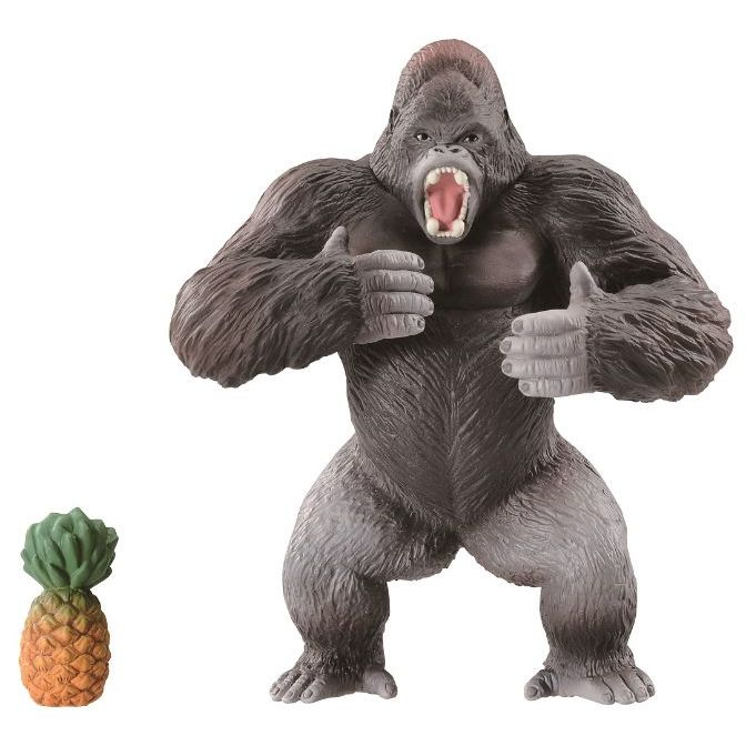 Gorilla toy giving thumbs up next to a pineapple toy.