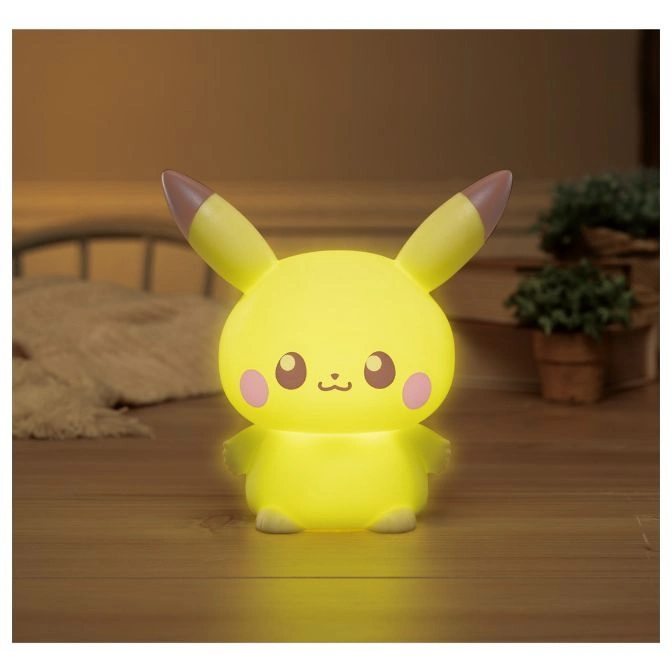  Illuminated Pikachu nightlight with pink cheeks and brown-tipped ears on a wooden surface.