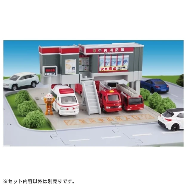  Toy fire station with vehicles and figure. Includes fire trucks, ambulance, and cars.